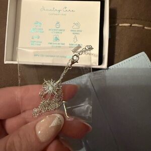 Silver Necklace with Blue Gemstone by [Brand]